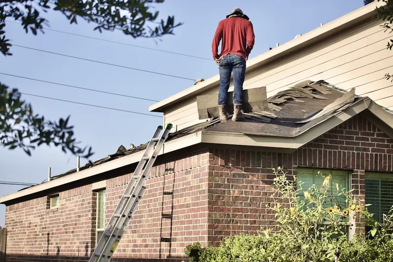 Professional roofer working on a residential roof in Toluca Terrace